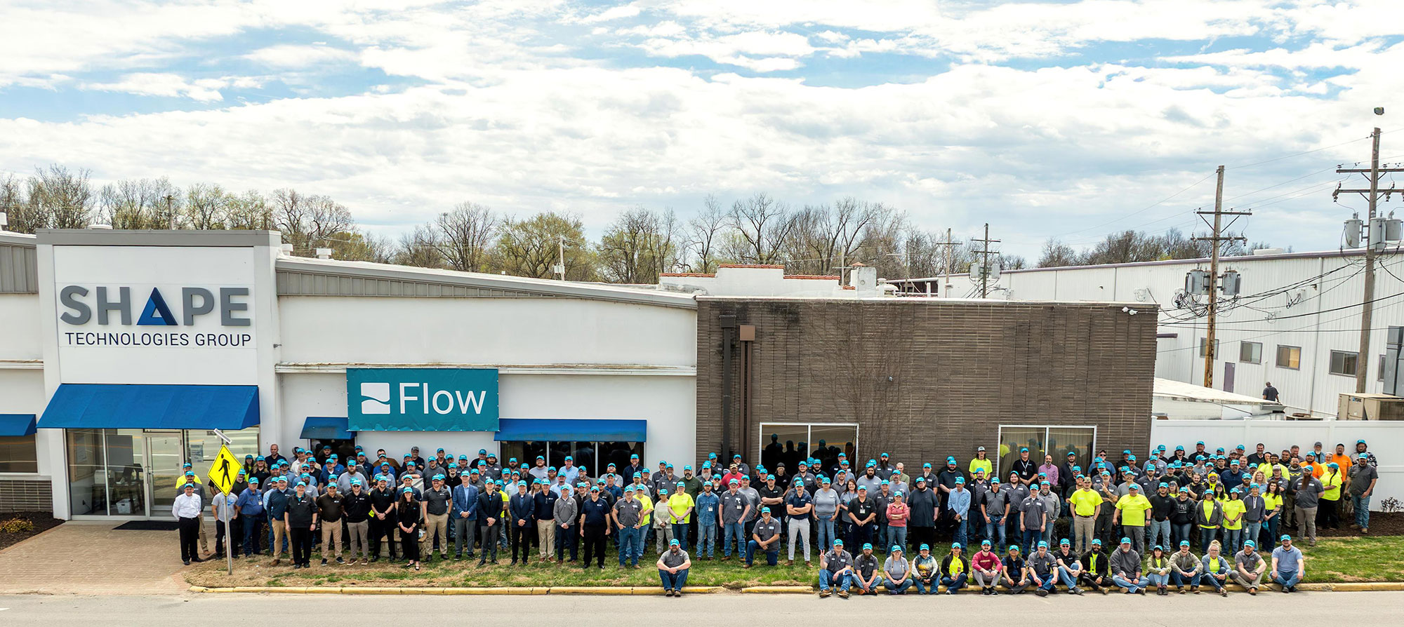 staff in front of the buildings that make up the Baxter Springs, KS Flow and SHAPE facilities
