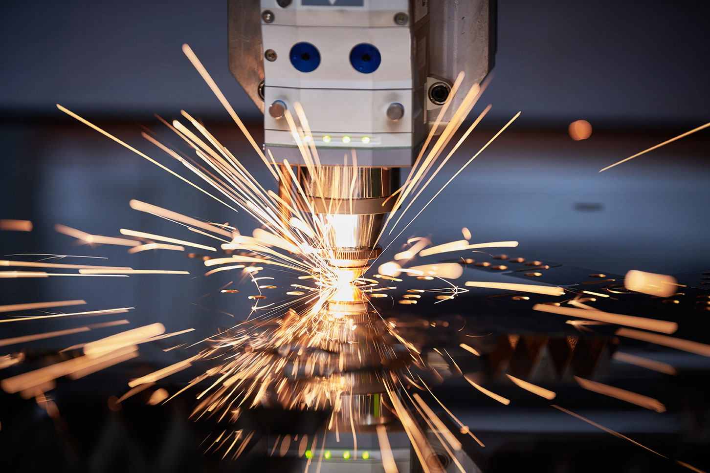 laser cutting metal with sparks flying