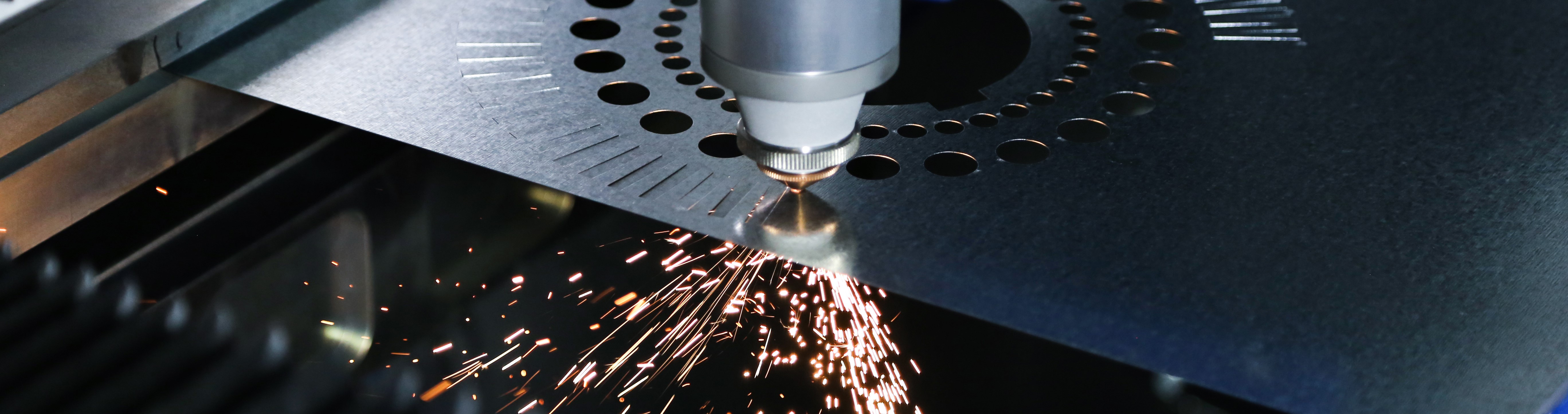 Fiber laser cutting oblong rectangles and circles into a sheet of metal