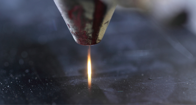 close up of the laser beam cutting metal