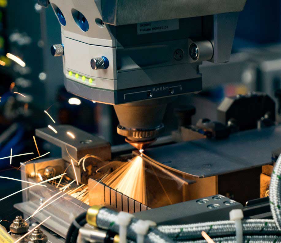 close-up of a cutting head on a fiber laser cutting metal