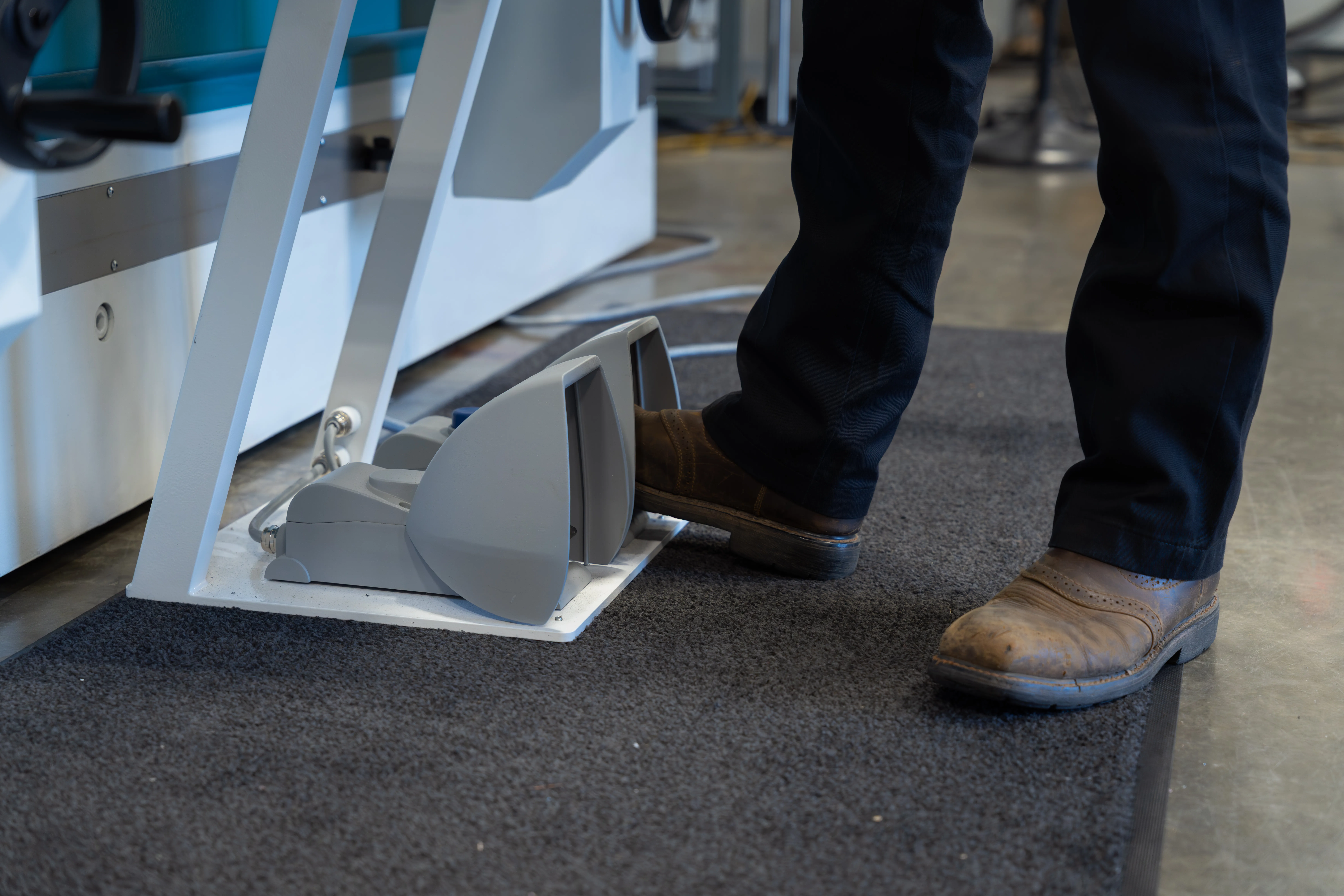 a pair of feet utilizing the foot controls at the base of the operator station on the HyperBend press brake